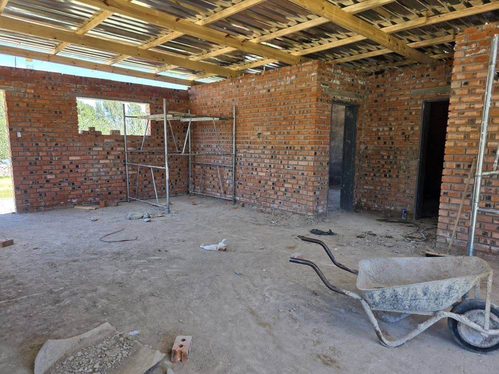 House under construction with exposed roof trusses